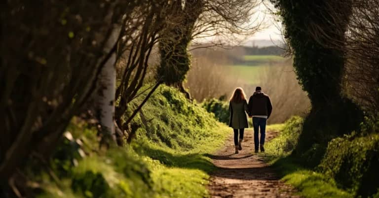 two people walking down a countryside lane helping each other out help someone else today